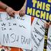 An Michigan State fan admits his confusion on a sign while watching a live broadcast of ESPN's "College GameDay" at Ingalls Mall on the University of Michigan campus on Saturday, September 7, 2013. Melanie Maxwell | AnnArbor.com